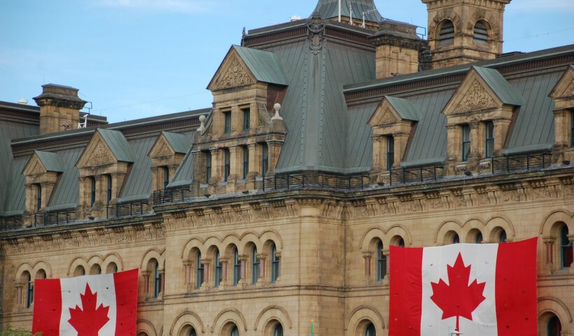 Canada flags hanging on concrete castle wall